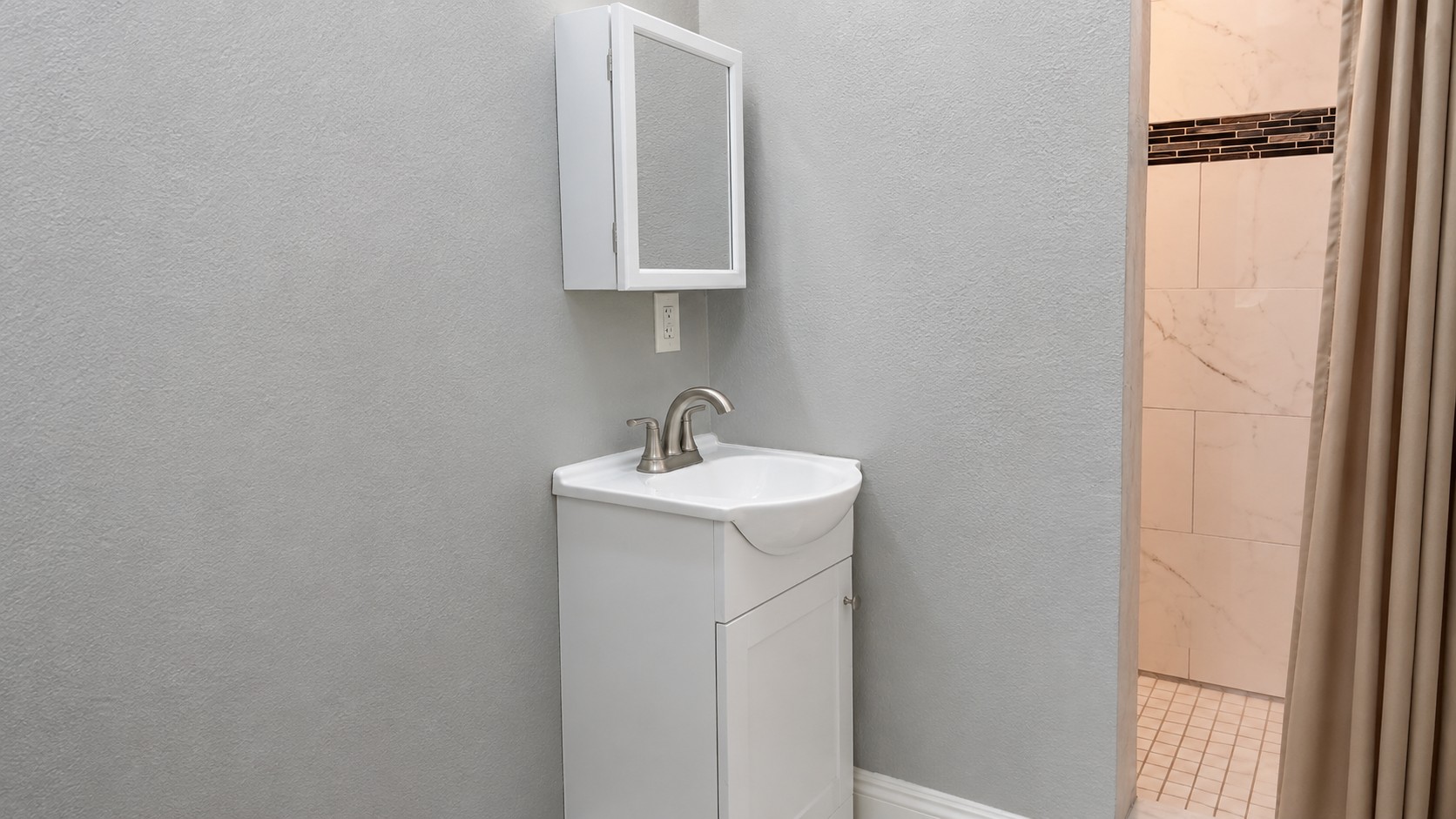 Compact bathroom showing a clean remodel with modern vanity, shower area, and updated finishes designed for a fresh, functional space.