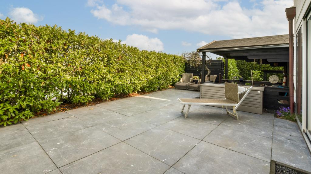Backyard patio installation in San Diego with large paving slabs and a covered seating area
