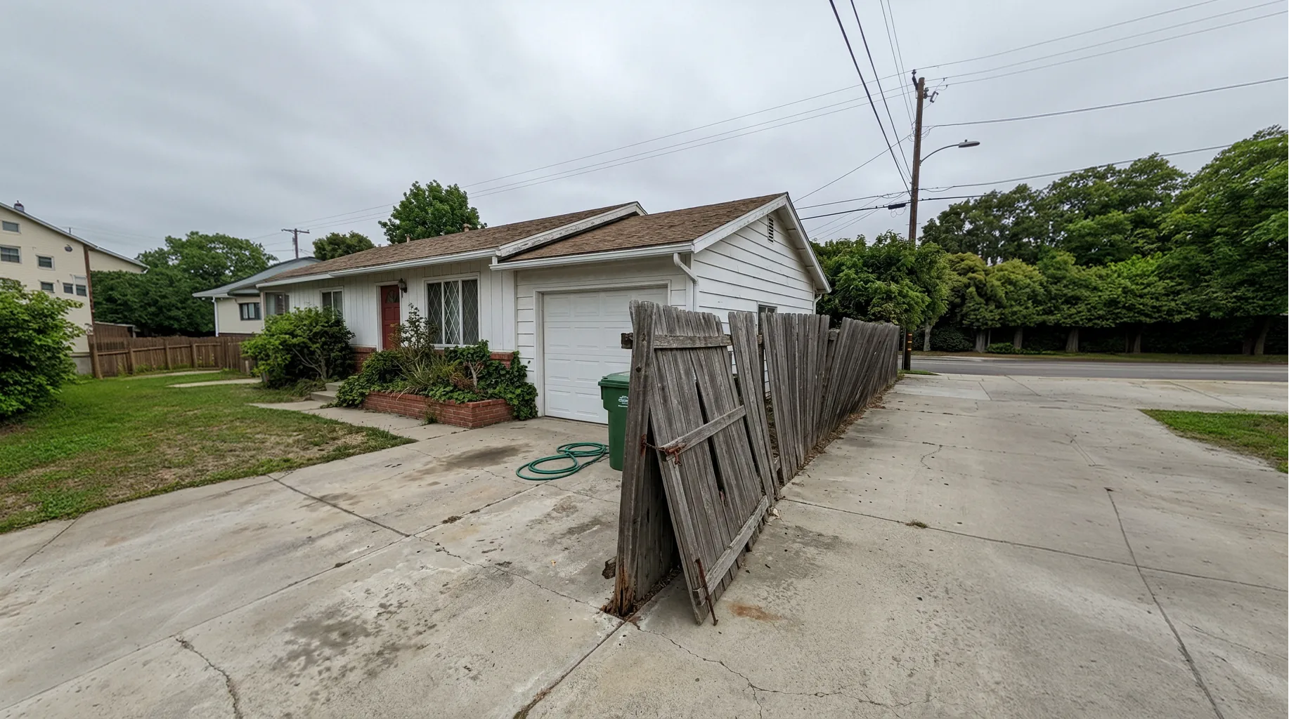 Leaning wood fence and sagging side gate on a San Diego home before a Shiro Builders Group fence replacement