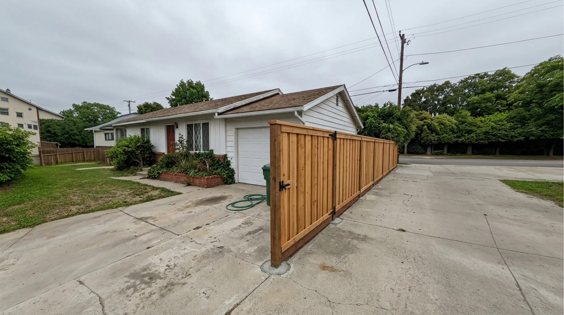 Finished cedar fence and side gate along a San Diego driveway by Shiro Builders Group