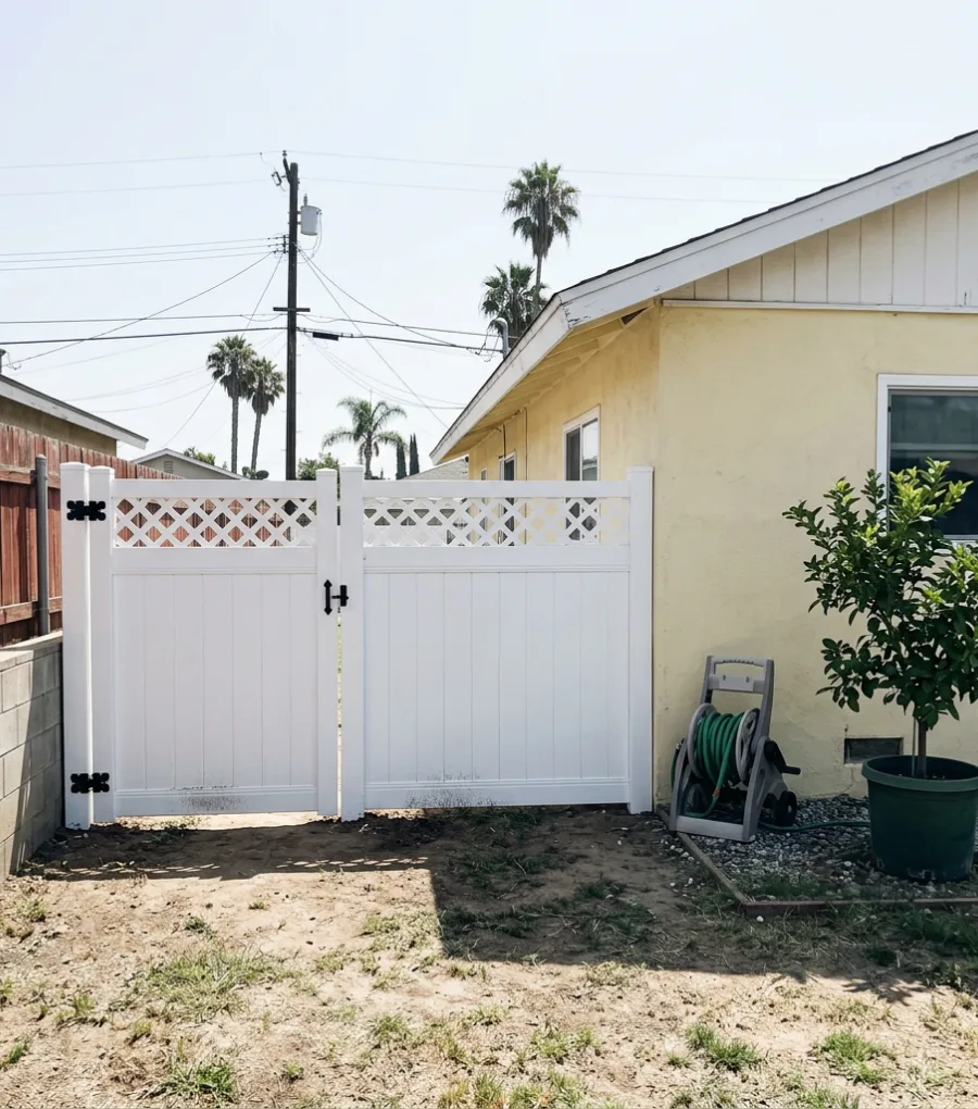 White vinyl privacy fence with reinforced gate in a San Diego backyard